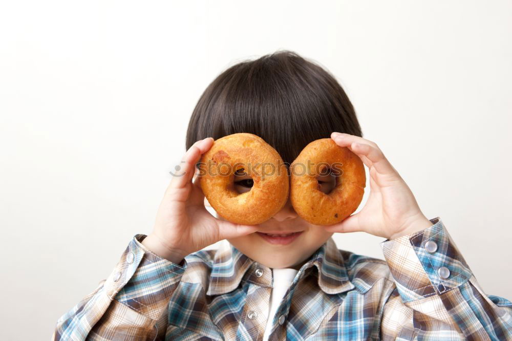 Similar – Young woman pulling funny face holding donuts in hands