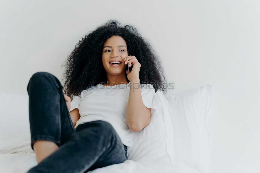 Similar – close up of a pretty black woman with curly hair smiling and lying on bed looking away