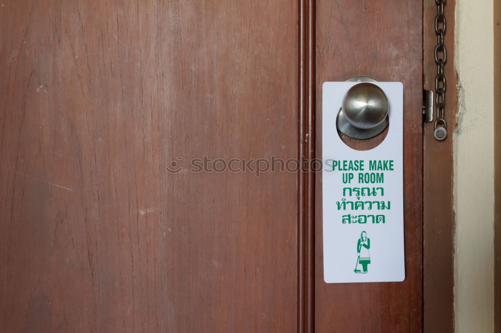 Similar – Funny hint on a front door. Press . Shield, door handle