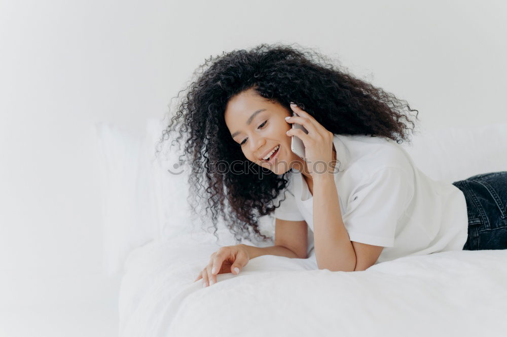 Similar – close up of a pretty black woman with curly hair smiling and lying on bed looking away