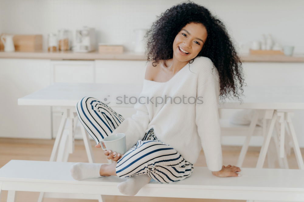 Happy beautiful young black woman relaxed sitting in the bed