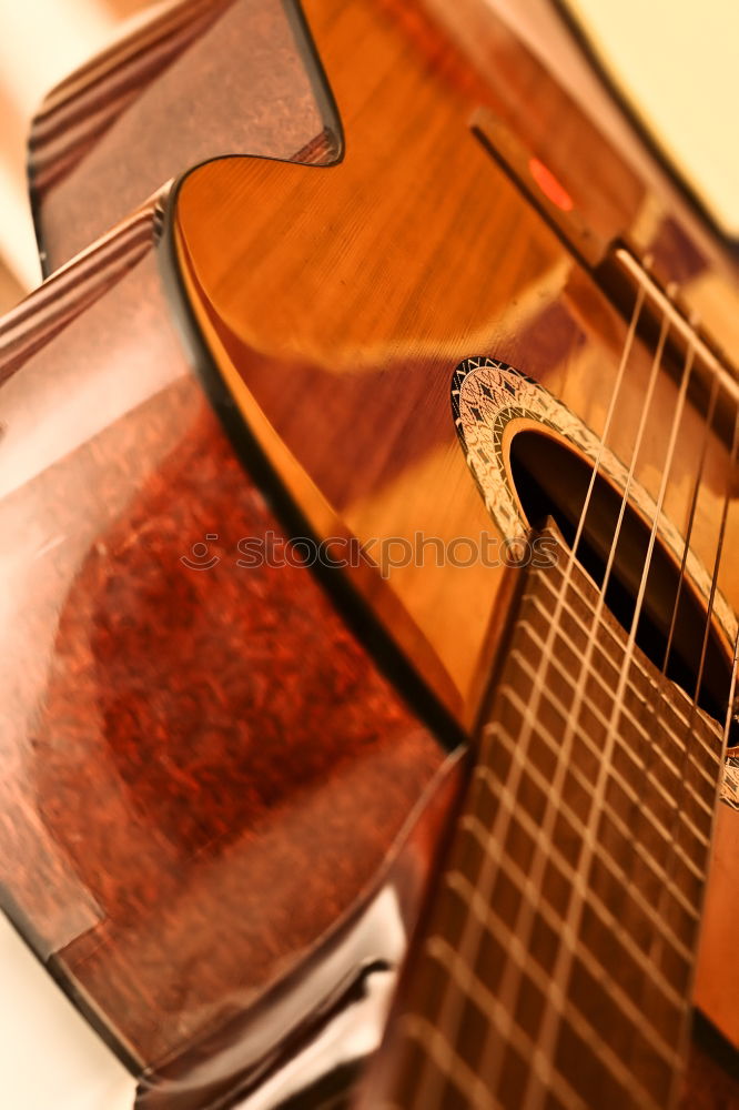 Similar – Image, Stock Photo Ukulele Hawaiian small guitar music instrument at sunset closeup photo. Beige brown gold colour palette shot with ukulele lying on windowsill in soft natural light.