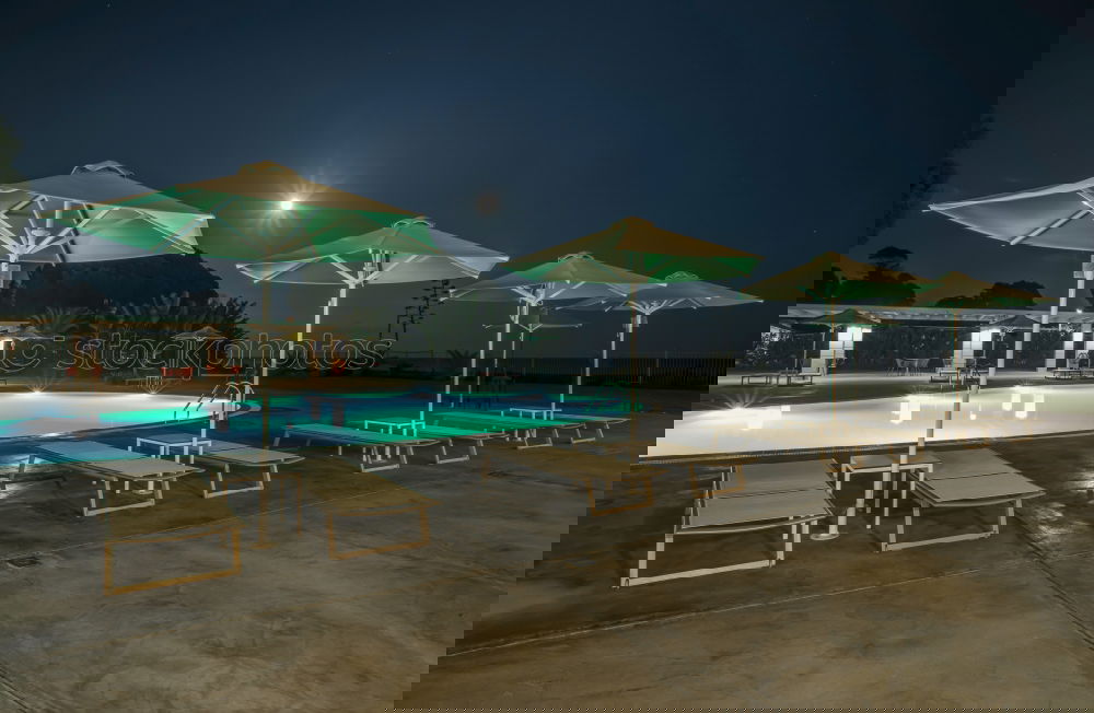 Similar – Image, Stock Photo Pool, sunbeds and umbrellas at night. Night lights.