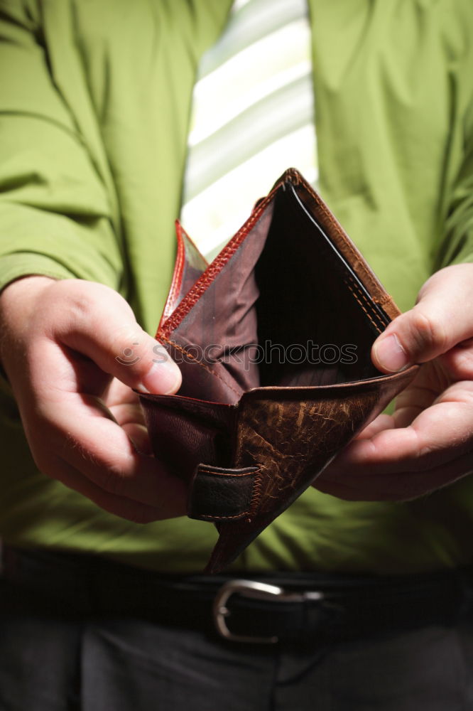 Similar – two female hands hold brown leather open empty wallet for cash