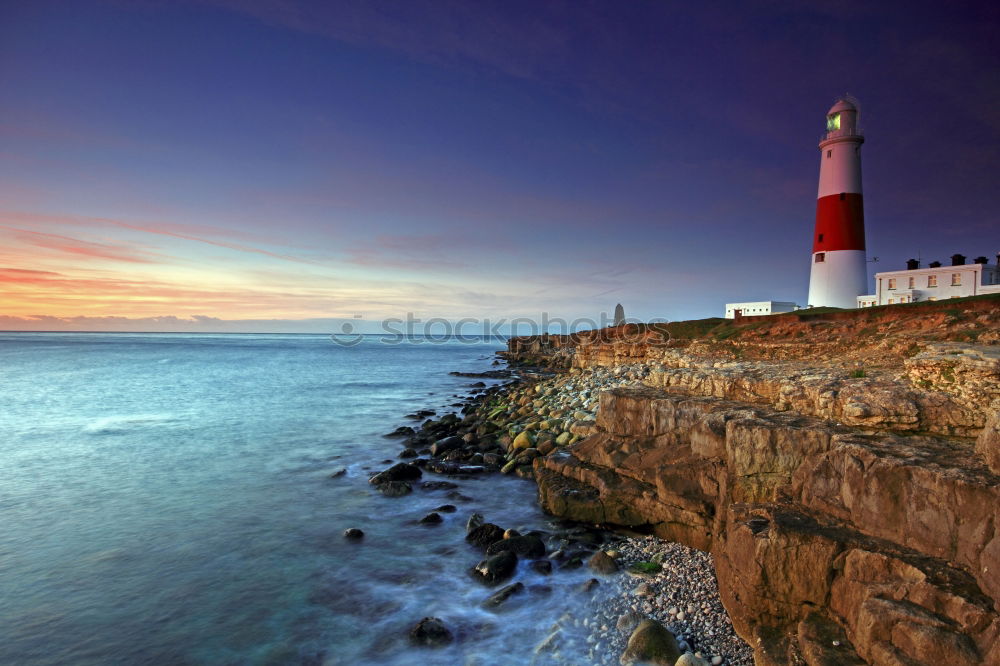 Similar – Felsenküste mit Leuchtturm in der Abenddämmerung