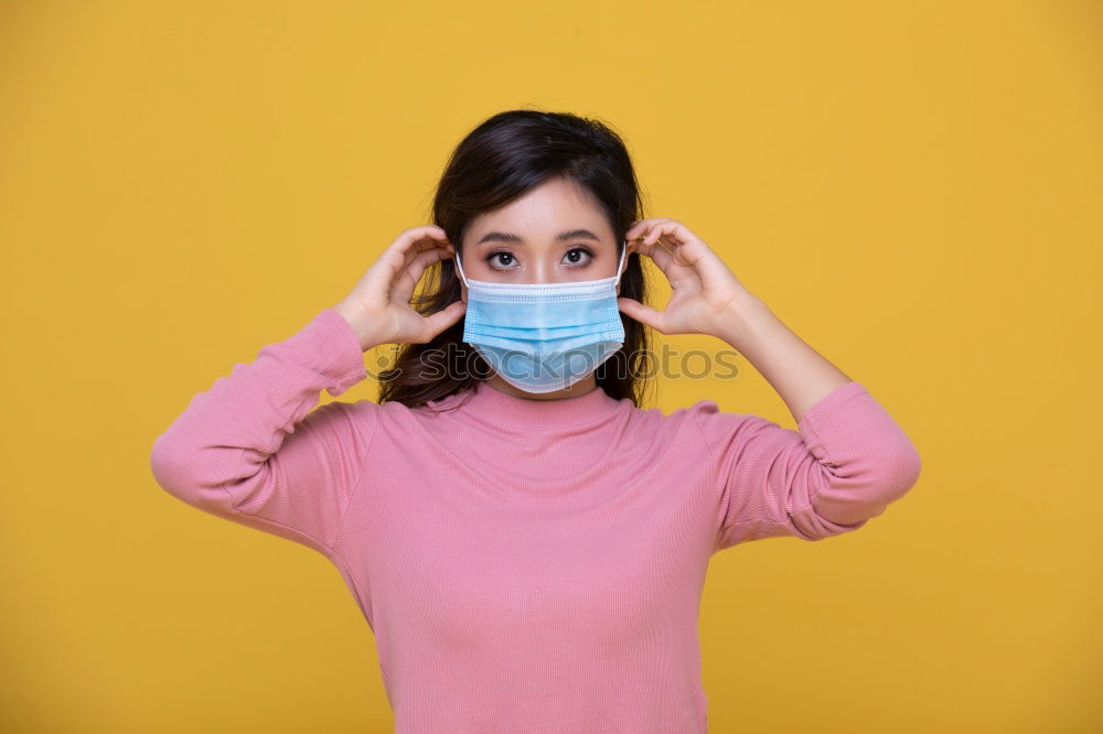 Similar – young woman who is wearing a mask under her nose in the wrong way