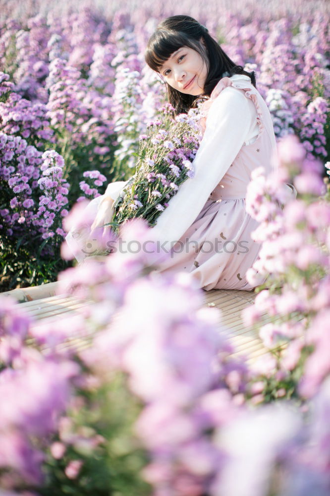 Happy young black woman surrounded by flowers