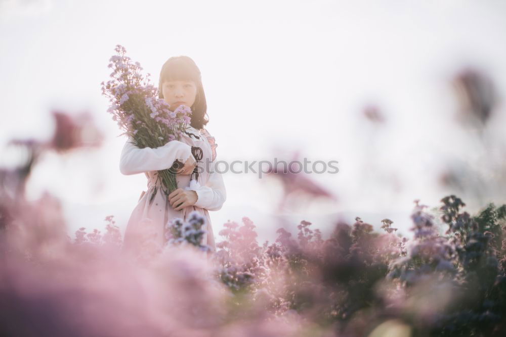 Similar – young hooded woman in a white sweatshirt with a serious look