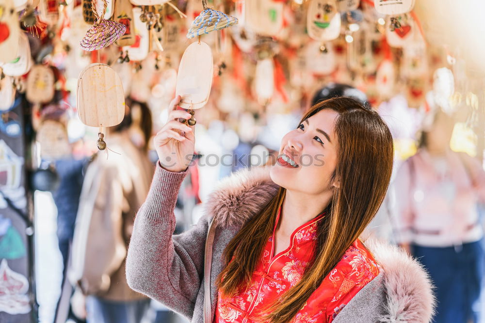 Woman smelling flower on market