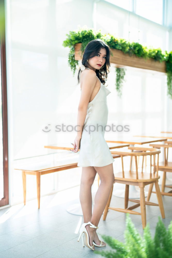 Similar – Beautiful young woman standing next to modern building.