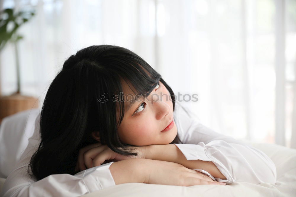 Similar – Portrait of a cute little girl with colored bracelets lying on her arm