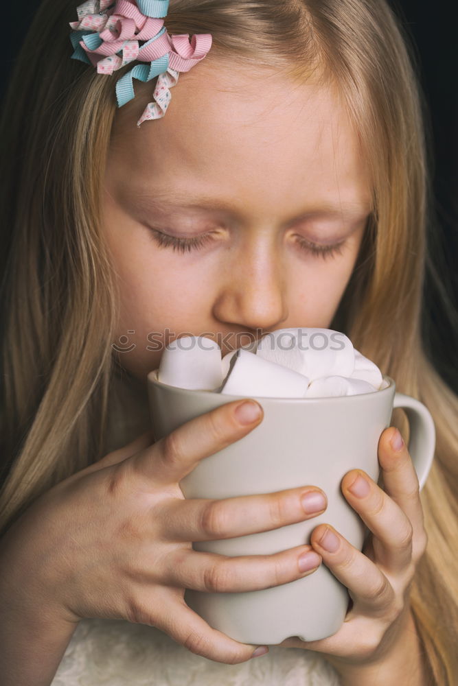 Similar – kid girl drinking hot cocoa at home in winter