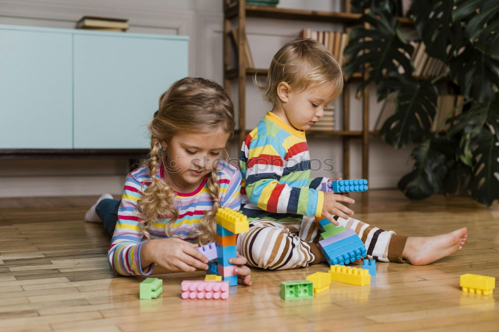 two beautiful sibling sisters playing at home