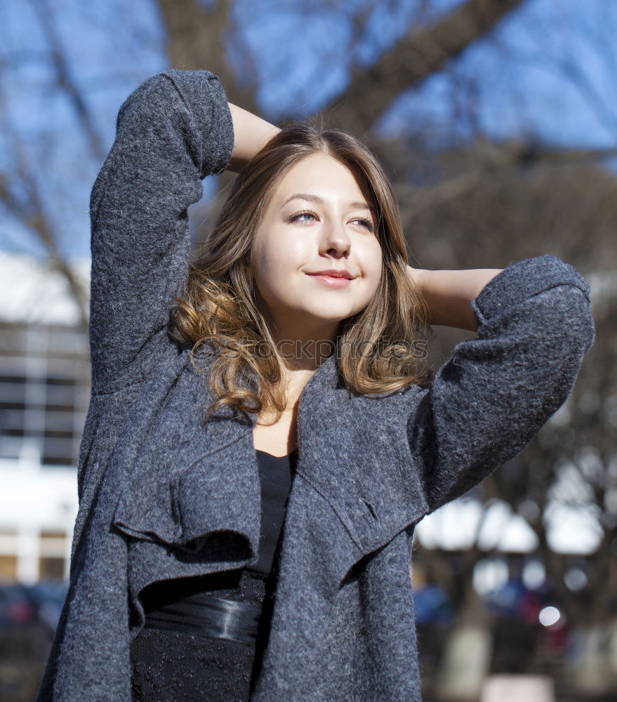 Similar – Young woman sitting on the street