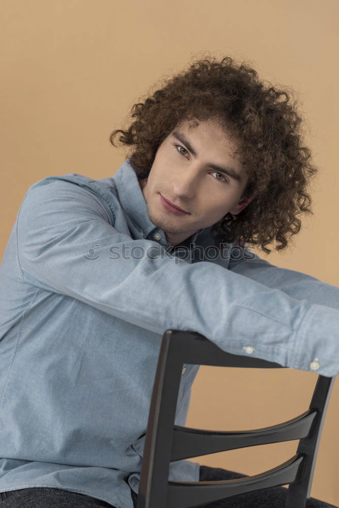 Similar – Image, Stock Photo young man with curly hair looking at camera with his longboard or skeateboard on his shoulders in the middle of the street