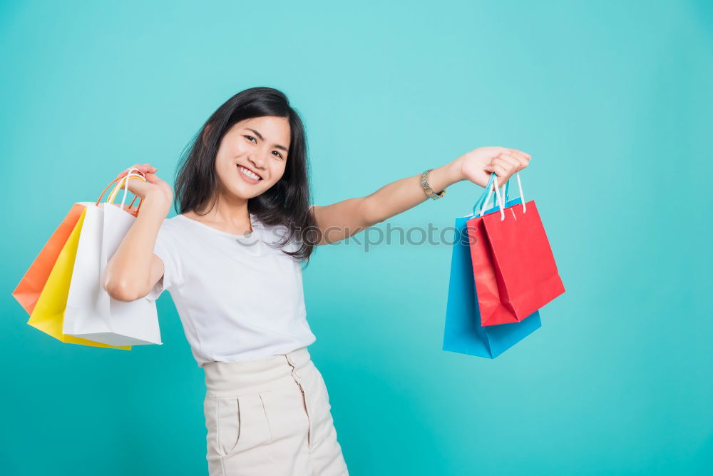 Similar – Foto Bild Einkaufstaschen an der Hand der Frau. Frau beim Einkaufen mit farbigen Papiertüten.