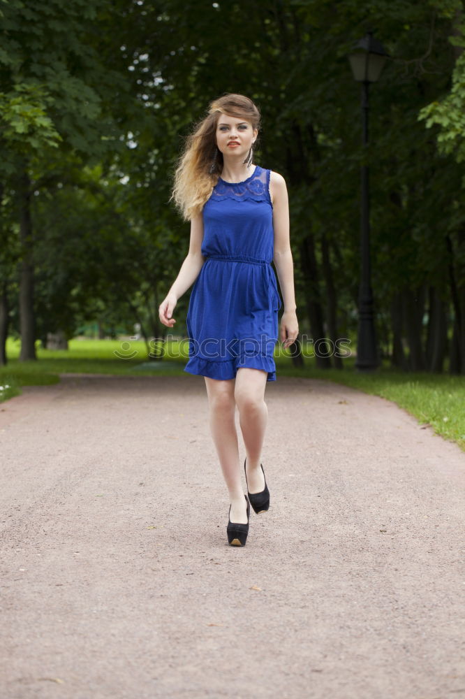 Similar – Image, Stock Photo Portrait of a young woman in a summer dress, standing in a field and turning around smiling