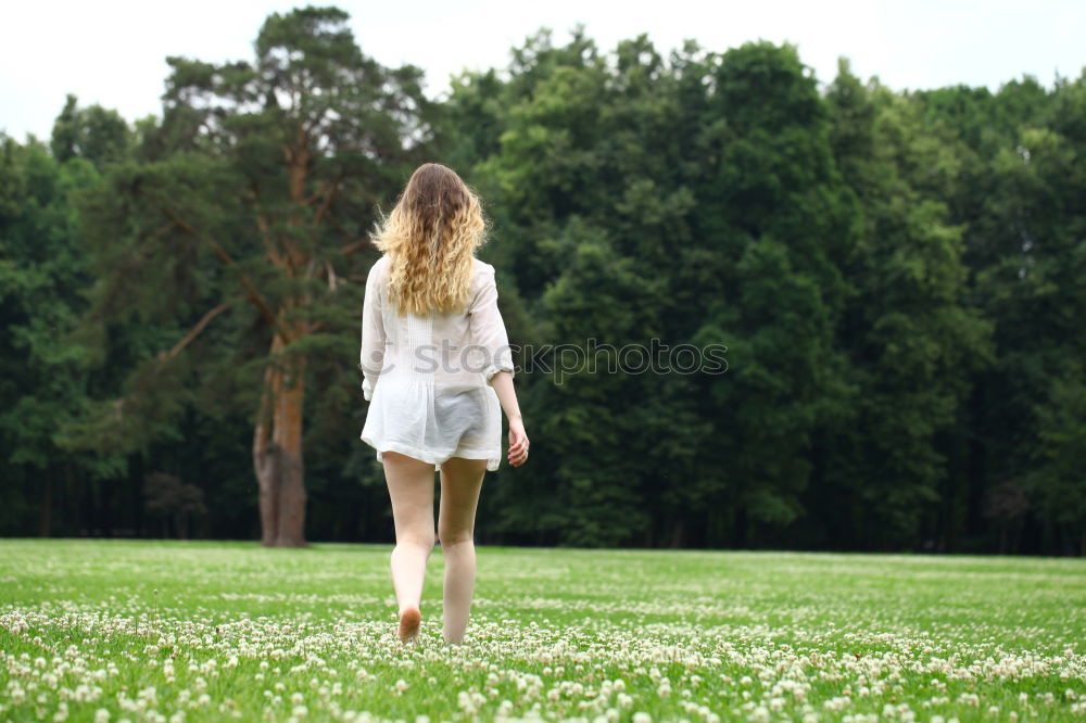 Similar – young woman on a meadow in the evening