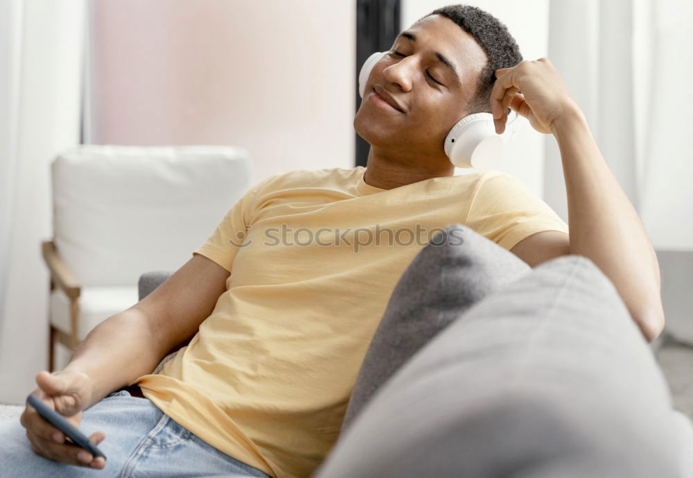 Similar – Portrait of a young thoughtful mixed race man sitting in the sofa