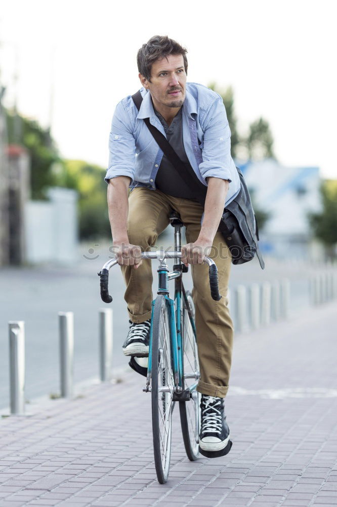 Similar – Man in the street wearing suit near a vintage bicycle.