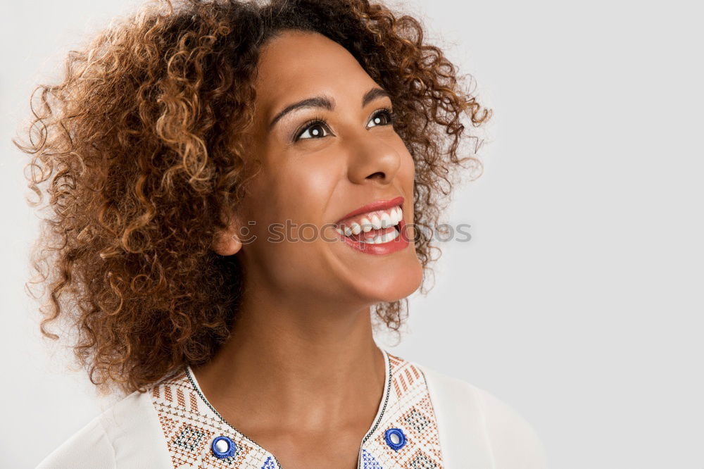 Similar – Young woman smiling with afro hairstyle and green eyes