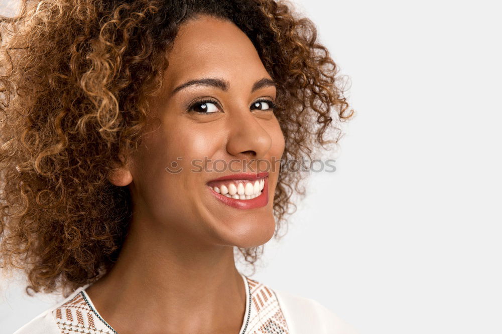 Similar – Young woman smiling with afro hairstyle and green eyes