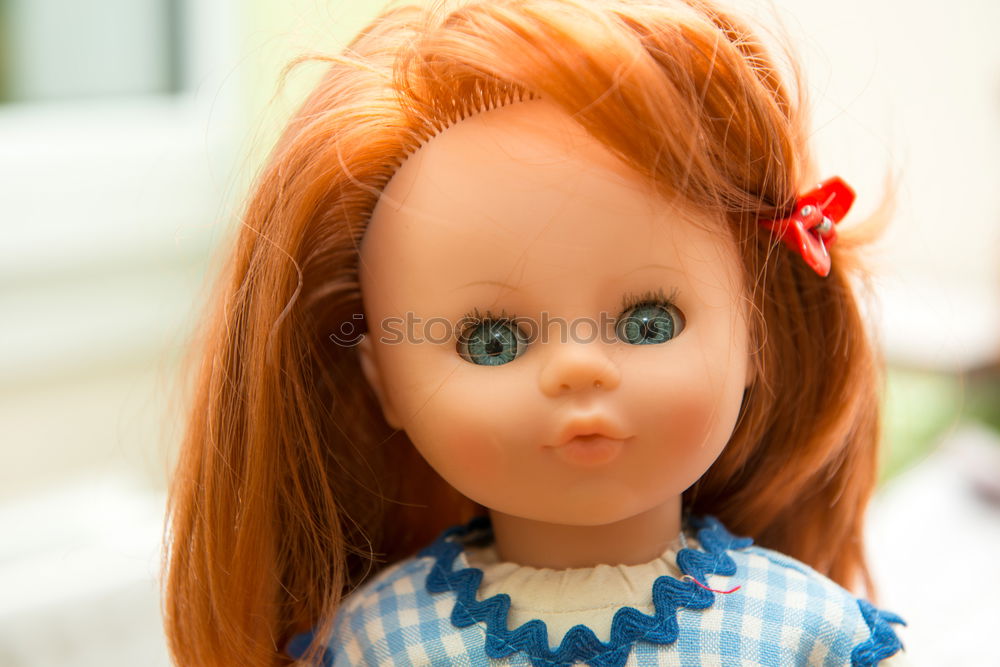 Similar – old doll with pigtails and a stare