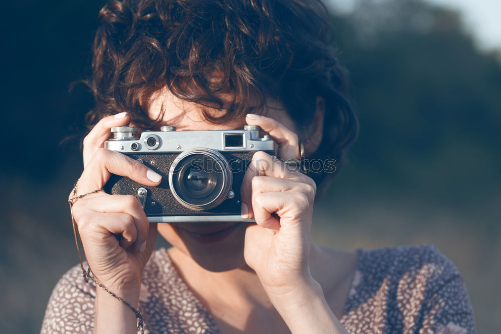 Similar – Young redhead woman taking shots with her analog camera