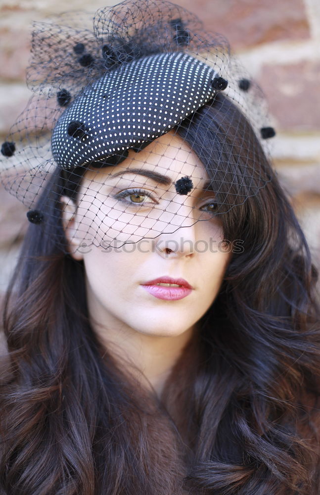 Similar – Young woman with black dress and red bow in her hair. Fashion photography. Autumn / winter fashion. Hair accessory.