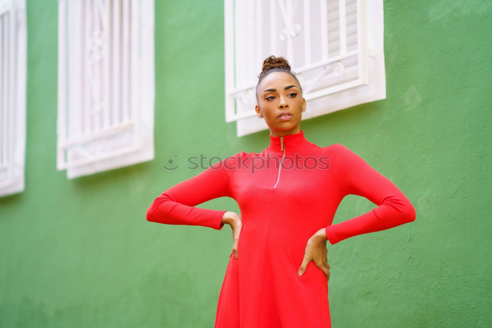 Similar – Happy black woman in red dress in front of a green wall