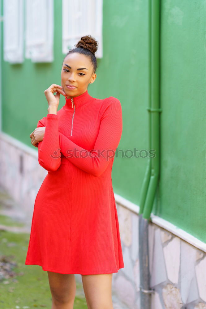 Similar – Happy black woman in red dress in front of a green wall