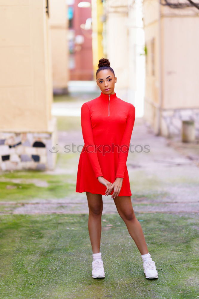 Similar – Happy black woman in red dress in front of a green wall