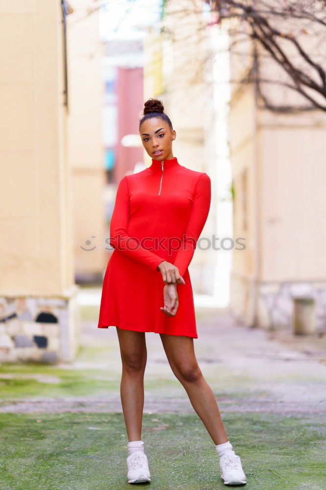 Similar – Happy black woman in red dress in front of a green wall