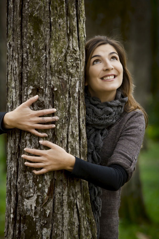 Similar – Image, Stock Photo Woman with knitted hat and coat hugs a tree, dreaming in nature.