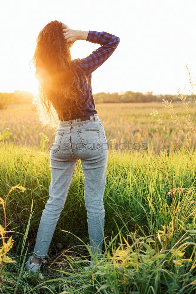 Similar – Image, Stock Photo Back view of a young woman in nature in a sunny autumn day