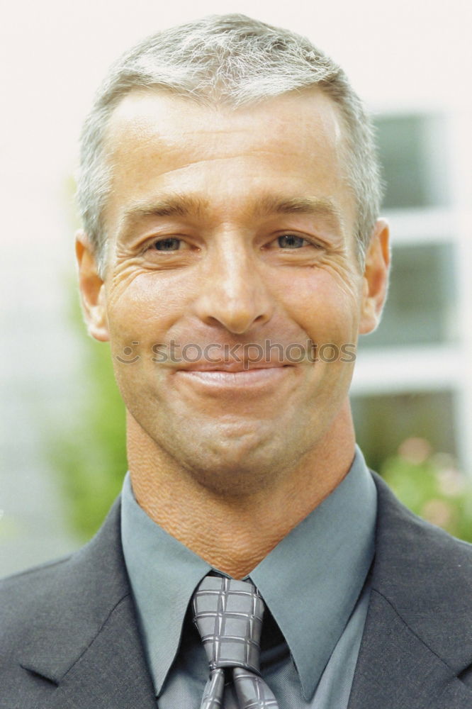 Similar – Portrait of a smiling senior with grey hair and grey beard in front of a grey sky