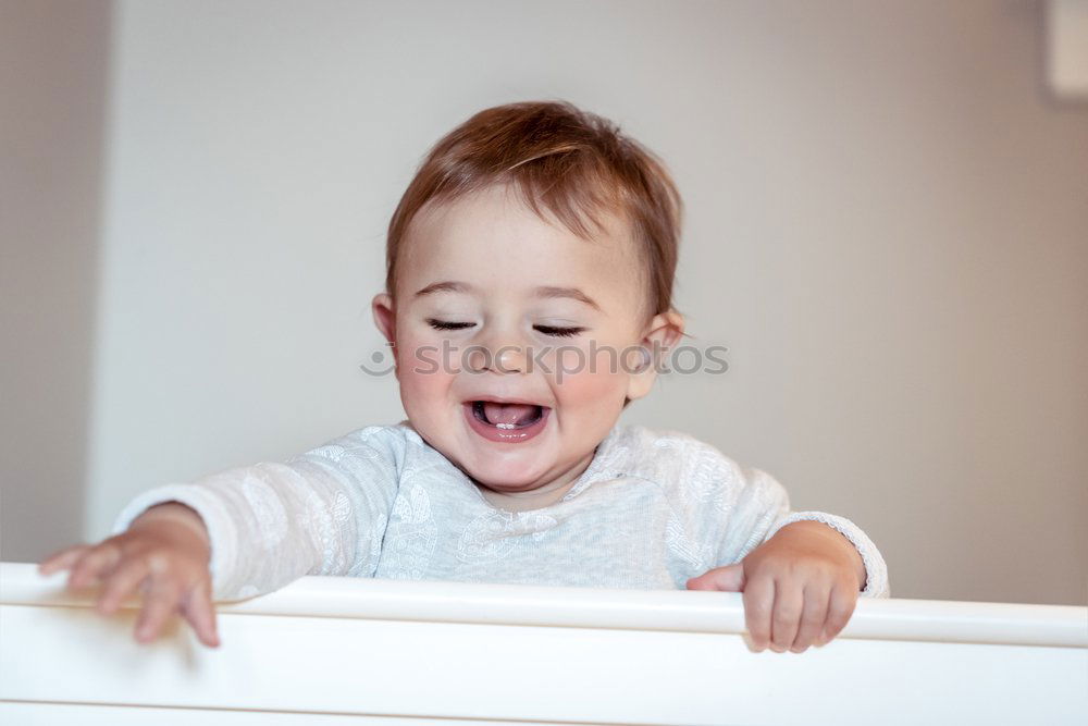 Image, Stock Photo 6 month old baby seated in high chair reaching into bowl of banana pieces; baby led weaning method