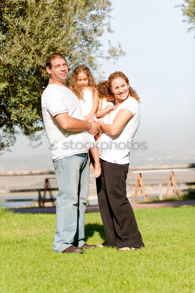 Similar – happy family of four hand in hand on the field