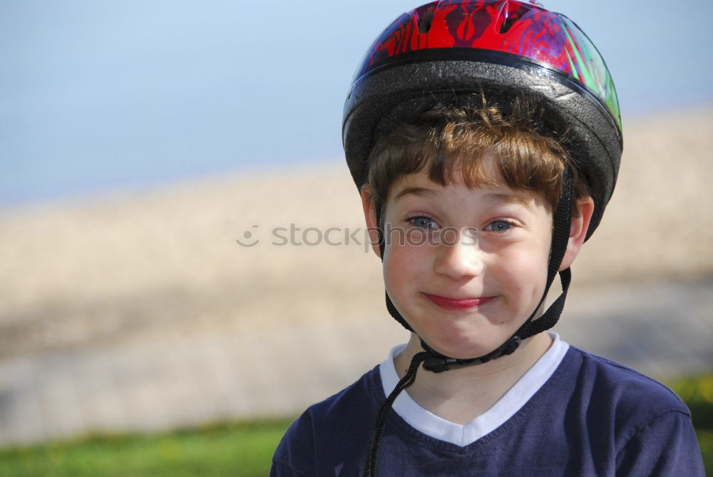 Similar – Cool gap | Portrait of a boy with a bicycle helmet and a tooth gap