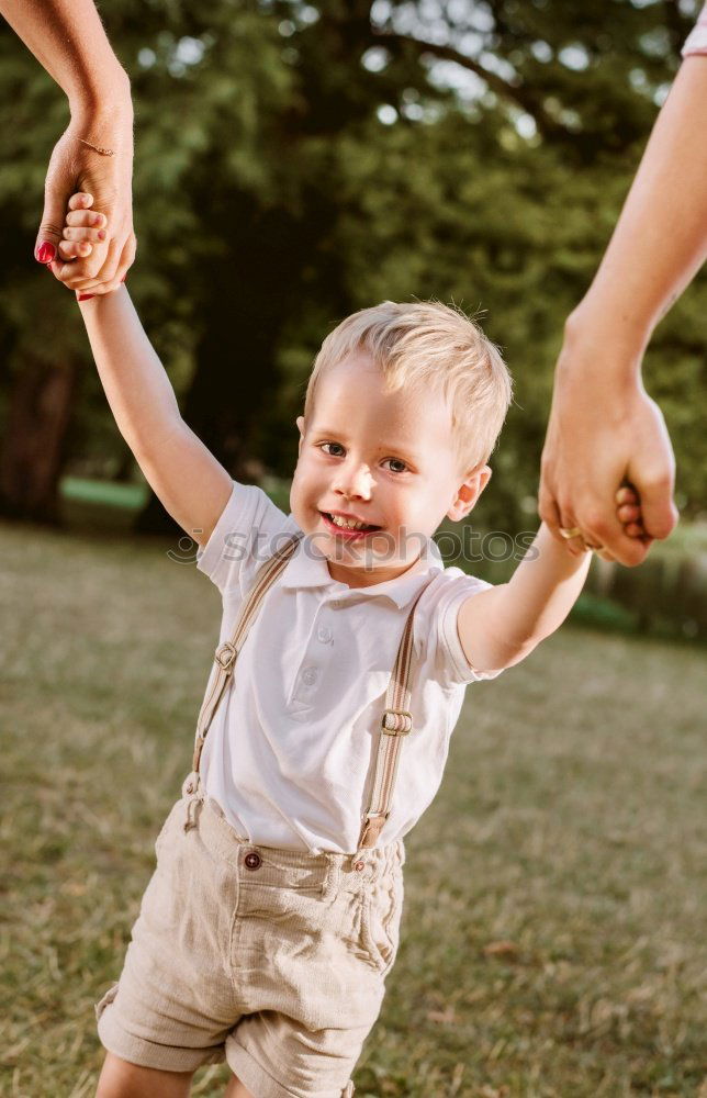 Similar – Image, Stock Photo Mother holding kid on hands in park