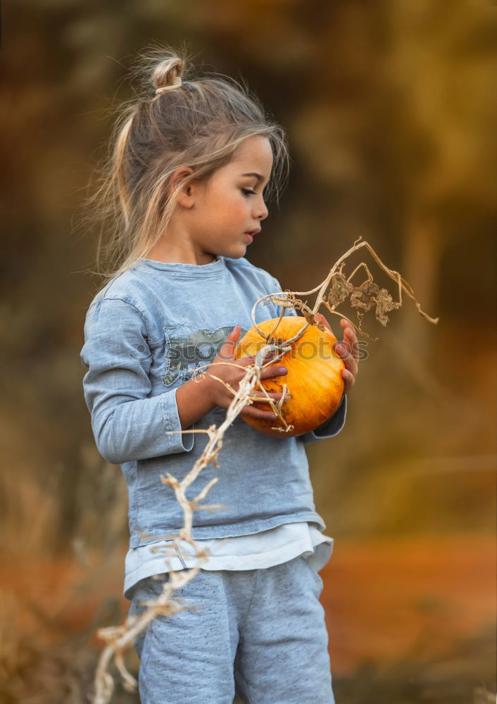 Cheerful kid in costume posing on tree