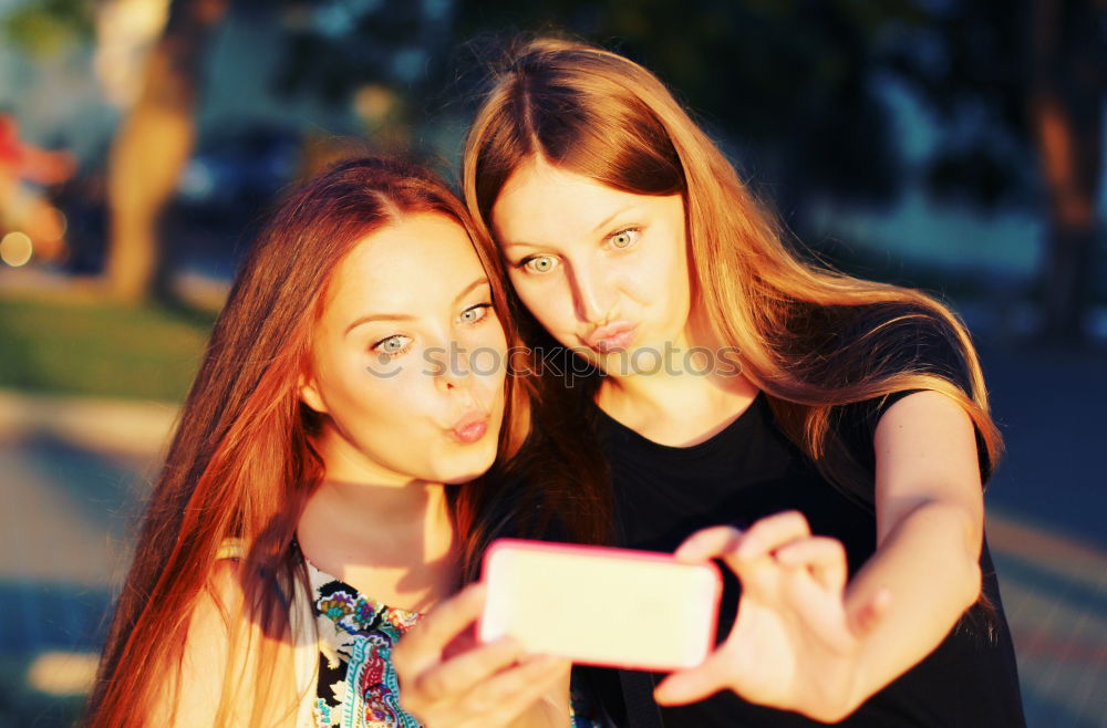 happy mother and daughter making selfie outdoor