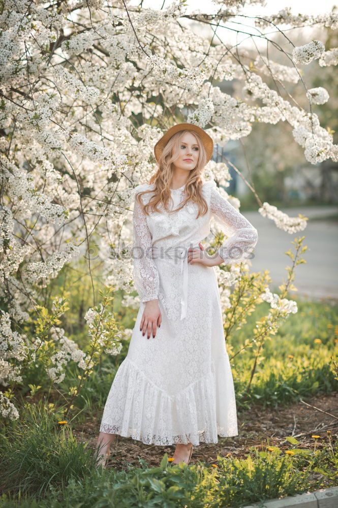 Similar – Young woman in almond flowered field in spring time