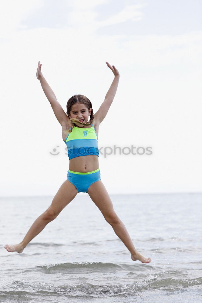 Similar – Playful girl standing in pier near lake