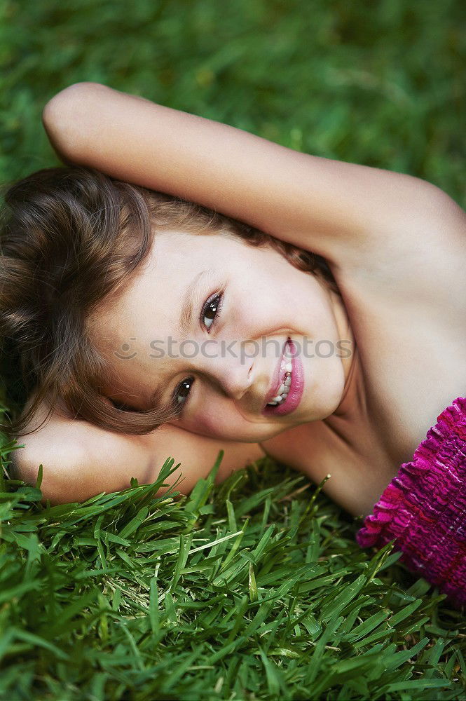 Similar – Excited girl in headphones on grass