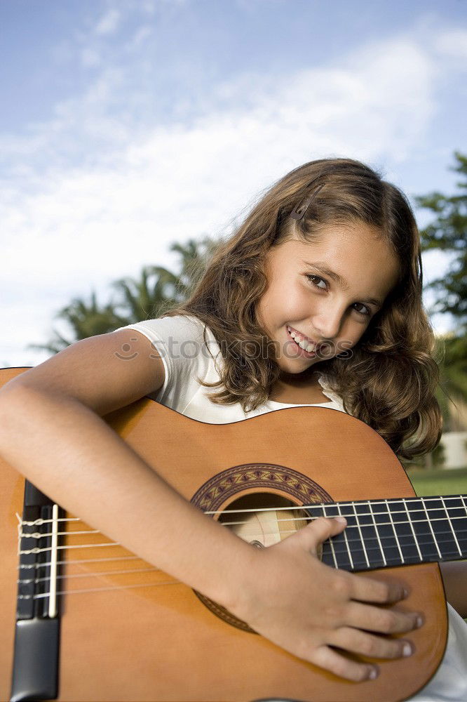 Similar – Beautiful woman playing guitar.