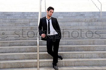 Similar – Young man with modern hairstyle sitting on stairs