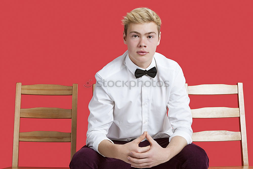 Similar – Portrait of a teenager with hoodie, in front of a red brick wall