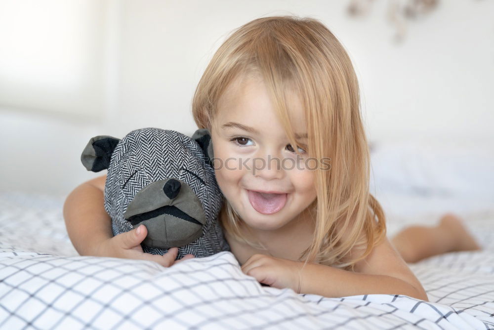 Similar – happy little child girl lying on her bed in the morning