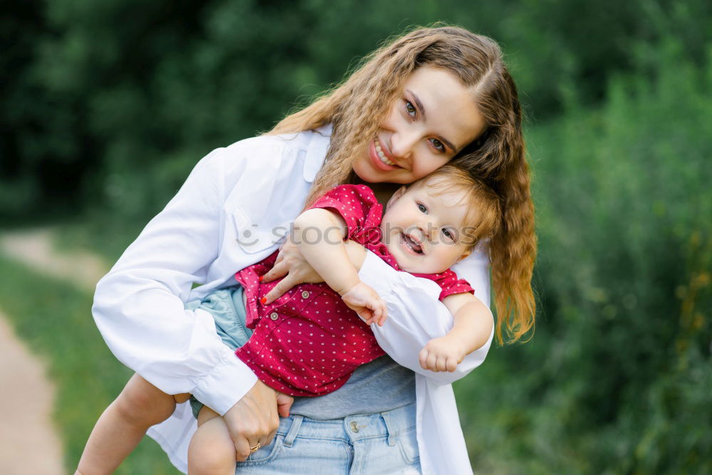 Similar – Mom reading a book her little daughter